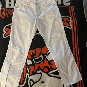 Distressed white ankle length button fly jeans